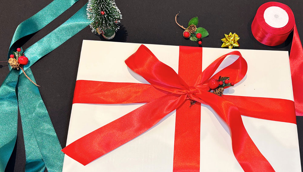 Holiday gift wrapping station with gift box and ribbon