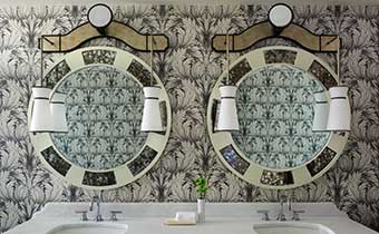 Oversized round mirrors and leaf wall coverings