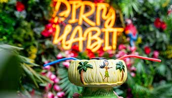 Tiki cocktail with Dirty Habit branding